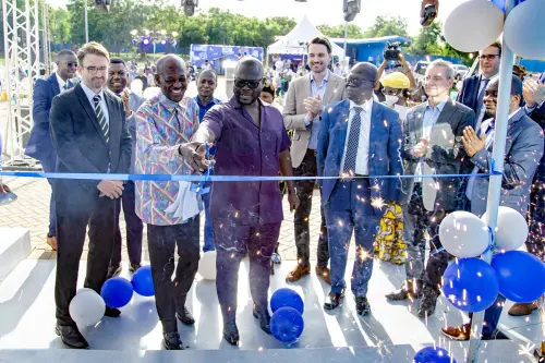 Francis Asenso-Boakye (centre), the Minister of Works and Housing in Ghana, cuts the blue ribbon and officially opens the new location of MC-Bauchemie Ghana in Accra. 